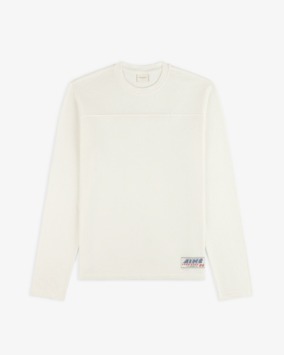 Off-white Long-Sleeve Mesh Football Tee with a small patch logo near the bottom hem.