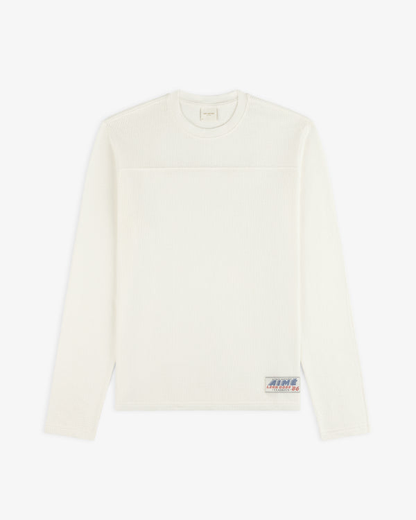 Off-white Long-Sleeve Mesh Football Tee with a small patch logo near the bottom hem.
