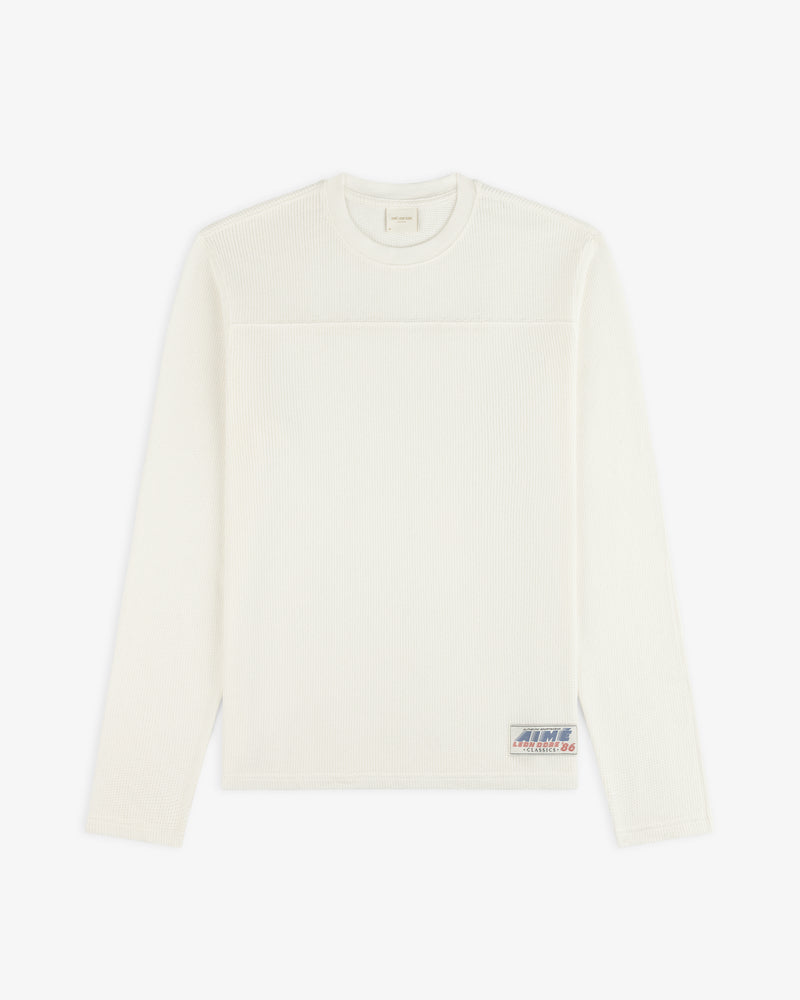 Off-white Long-Sleeve Mesh Football Tee with a small patch logo near the bottom hem.