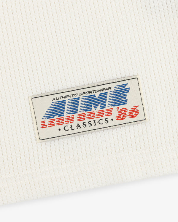 White ribbed Long-Sleeve Mesh Football Tee with a rectangular “AUTHENTIC SPORTSWEAR LION BASE 86 CLASSICS” patch.