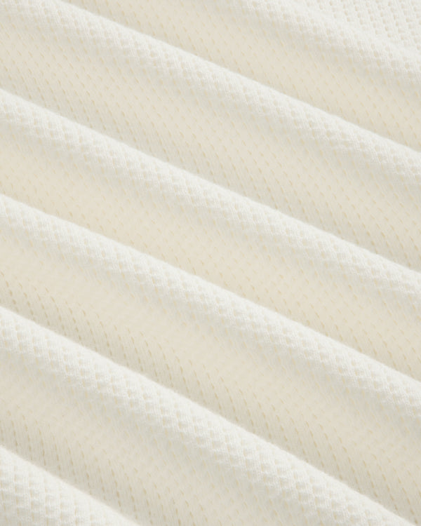 Close-up of Long-Sleeve Mesh Football Tee’s white, textured fabric with diagonal ridges and diamond pattern.