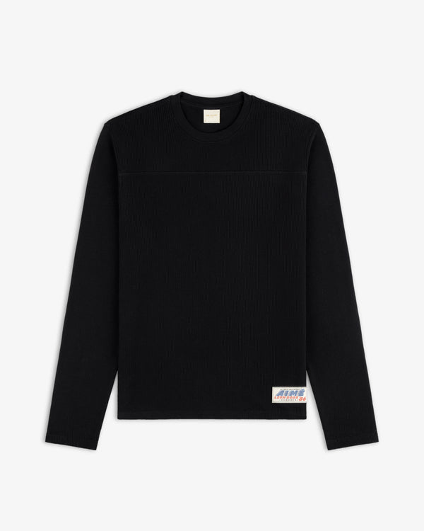 Long-Sleeve Mesh Football Tee in black with a small bottom-right patch, shown on a white background.