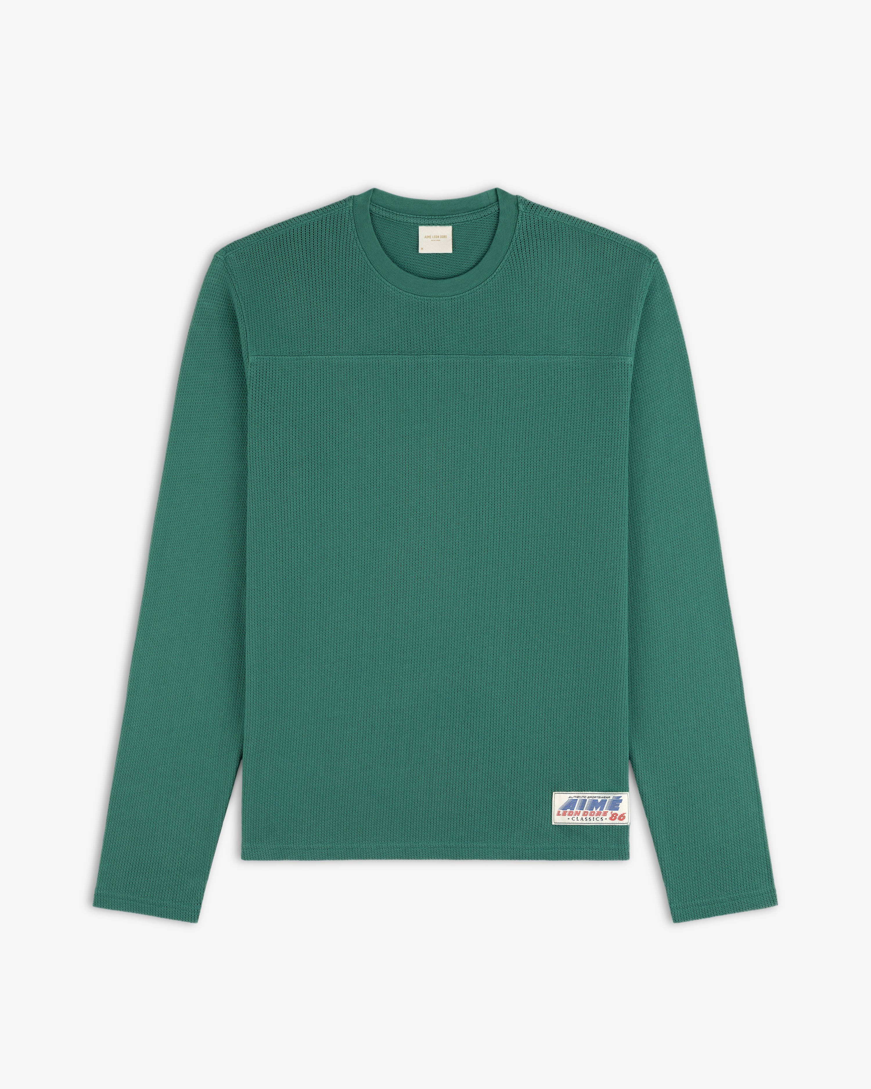 Long-Sleeve Mesh Football Tee in green, features a white patch on the lower front right.
