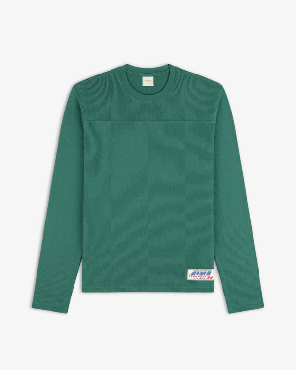 Long-Sleeve Mesh Football Tee in green, features a white patch on the lower front right.
