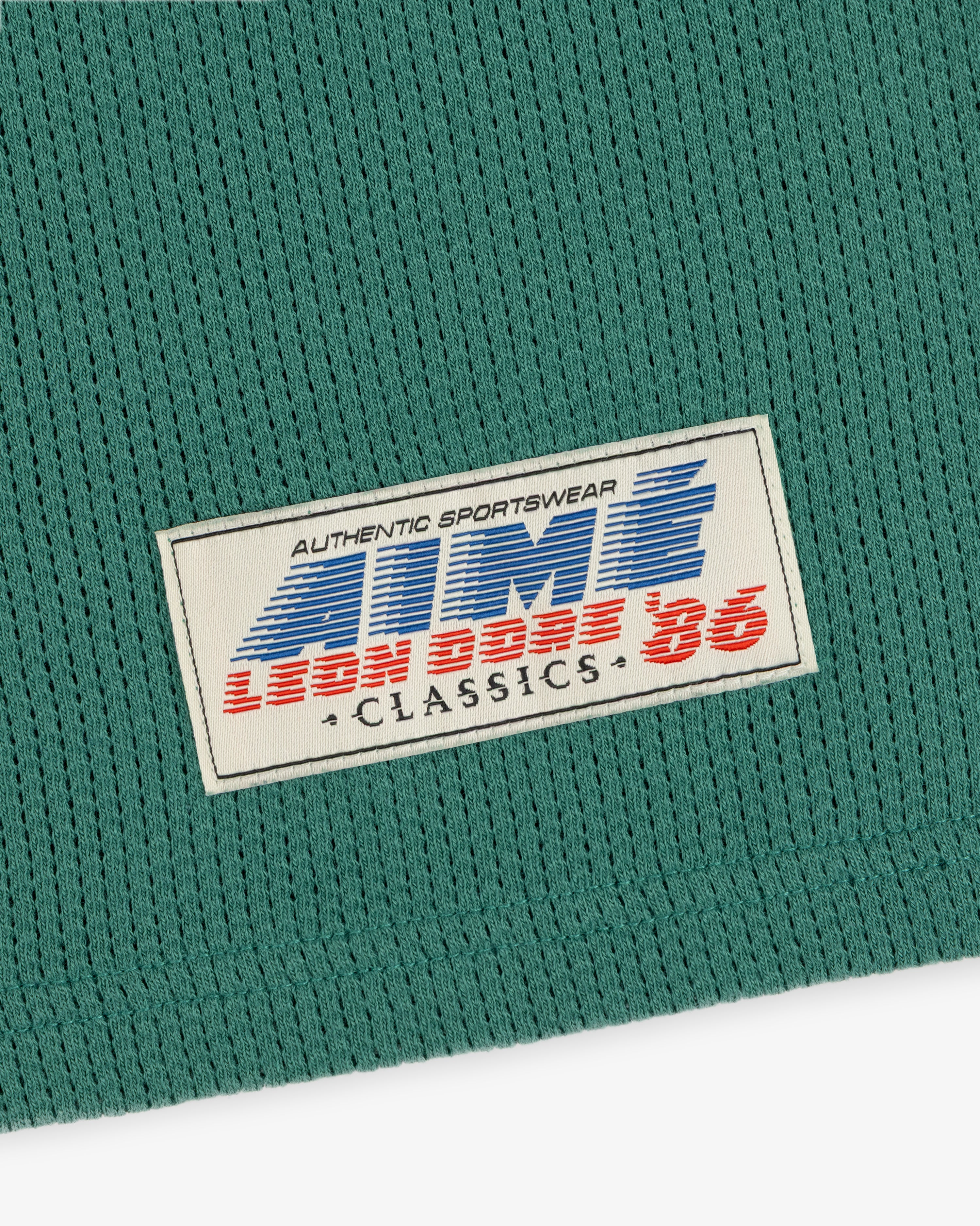 Green Long-Sleeve Mesh Football Tee with white label reading AUTHENTIC SPORTSWEAR LION BROS 86 CLASSICS.