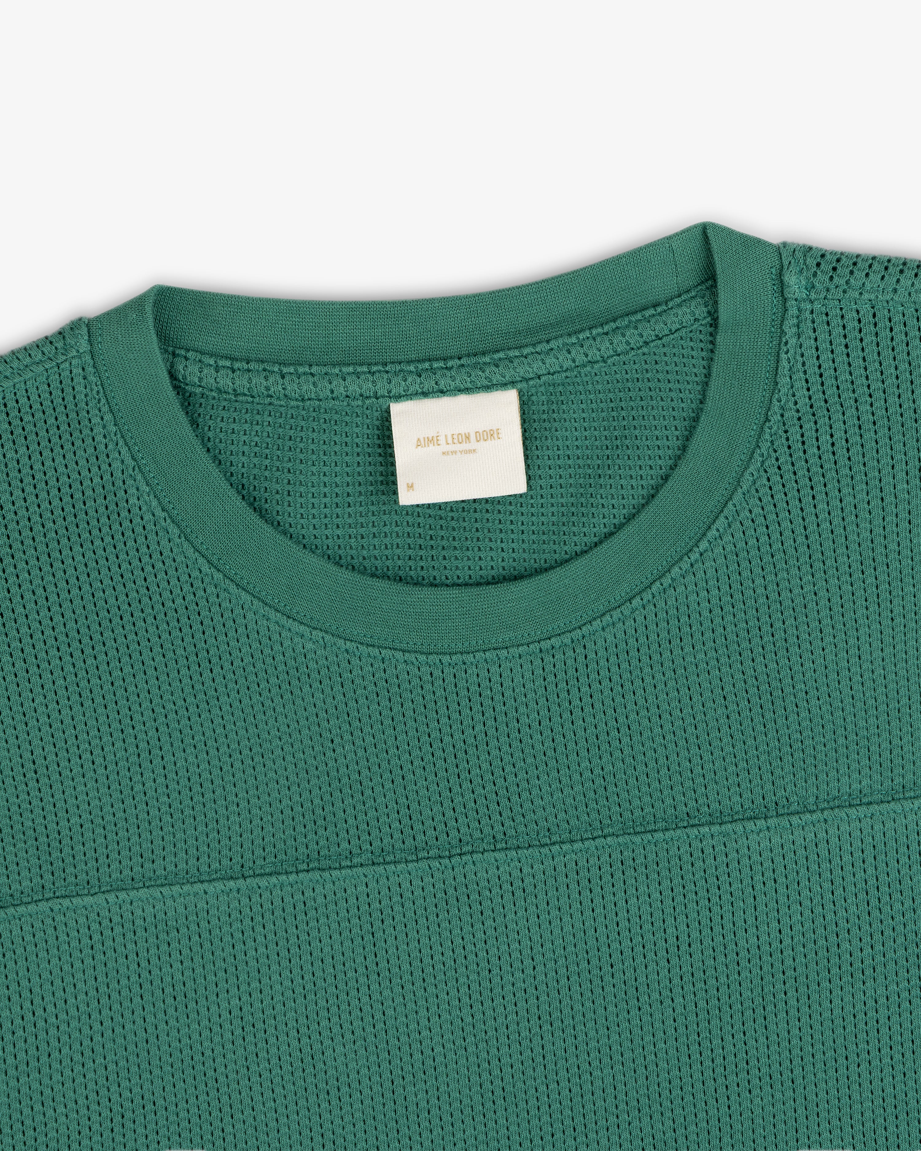 Green Long-Sleeve Mesh Football Tee with visible inner collar label, displayed flat on a white background.