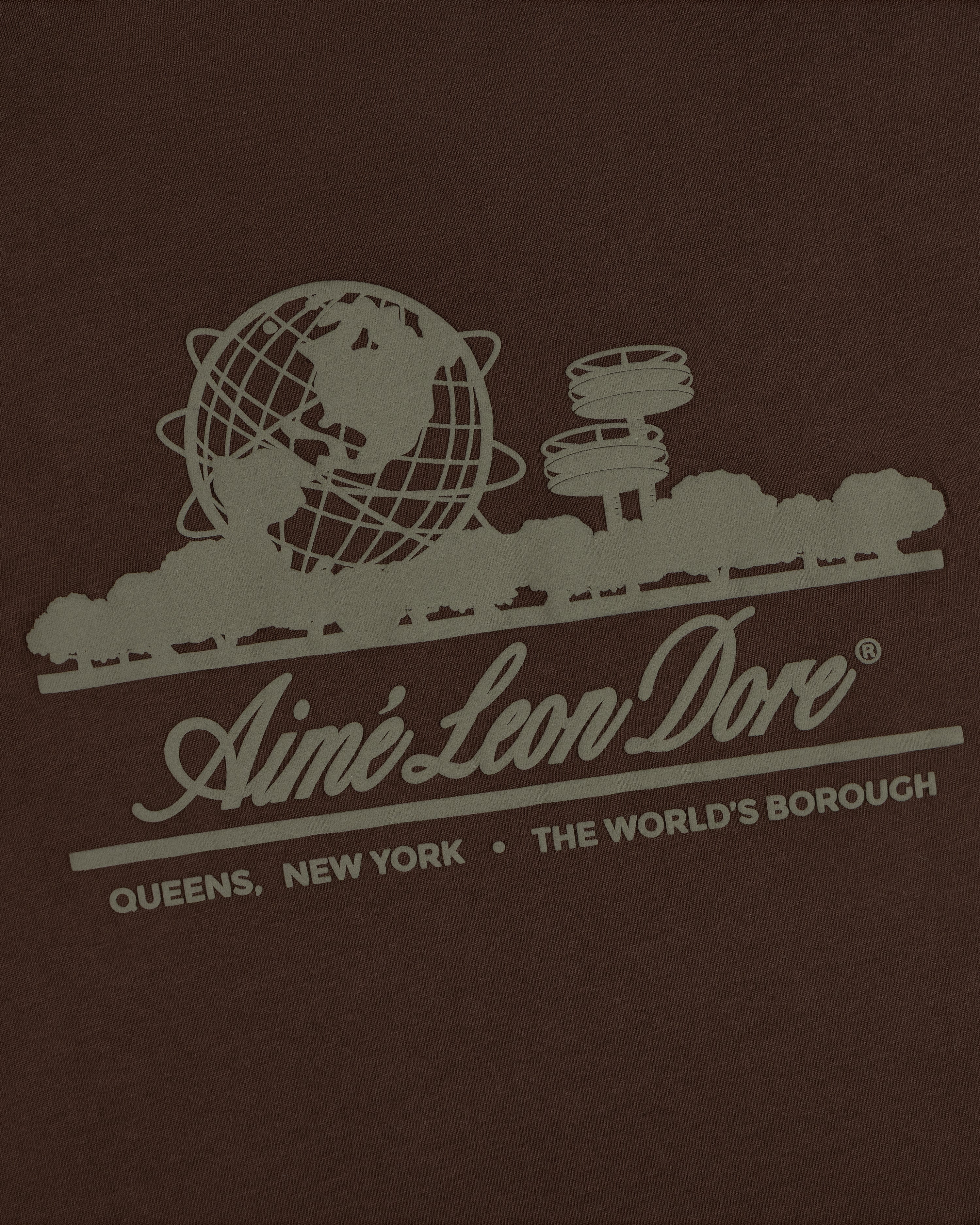 Unisphere Tee featuring a graphic of the Unisphere, trees, and “Aimé Leon Dore. Queens, New York. The Worlds Borough.”.