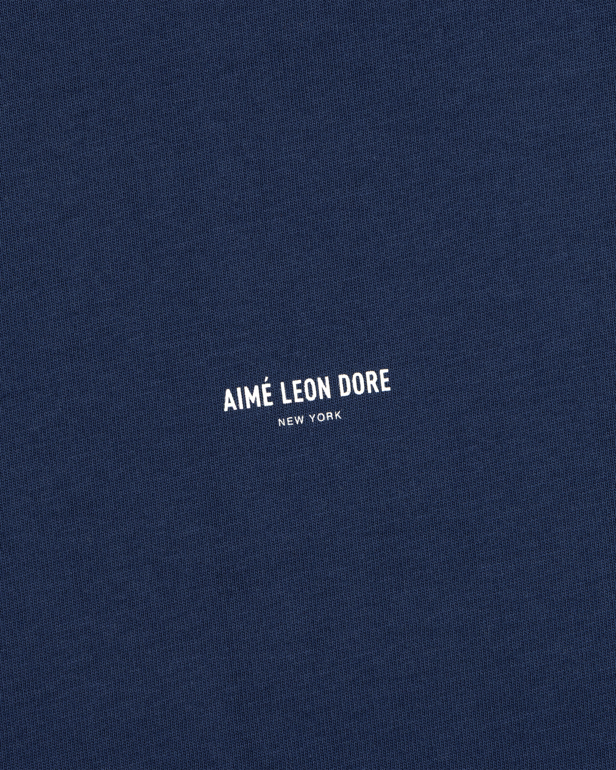 Navy blue Micro Logo Tee with AIMÉ LEON DORE NEW YORK in small white print at the center.