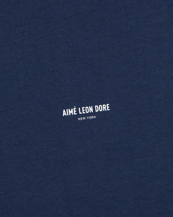 Navy blue Micro Logo Tee with AIMÉ LEON DORE NEW YORK in small white print at the center.