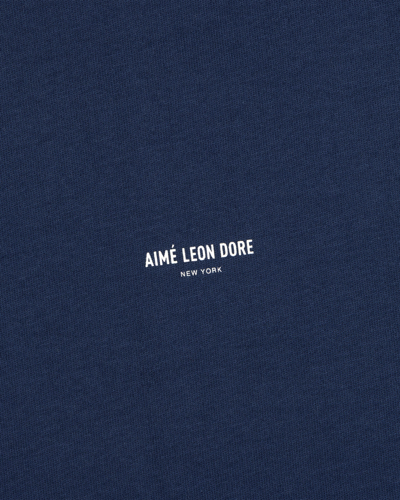 Navy blue Micro Logo Tee with AIMÉ LEON DORE NEW YORK in small white print at the center.
