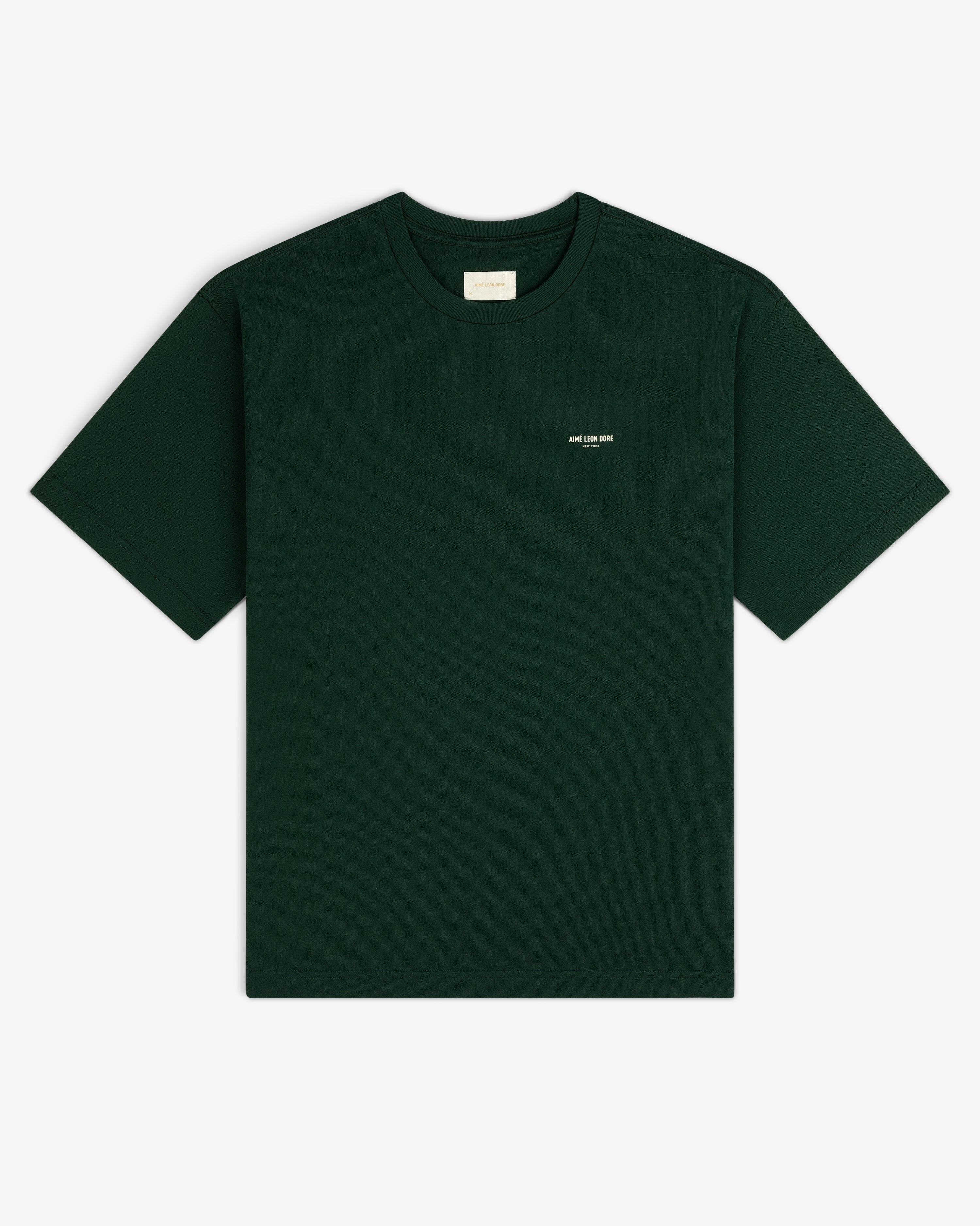 Dark green Micro Logo Tee with small white chest text, shown on a white background.