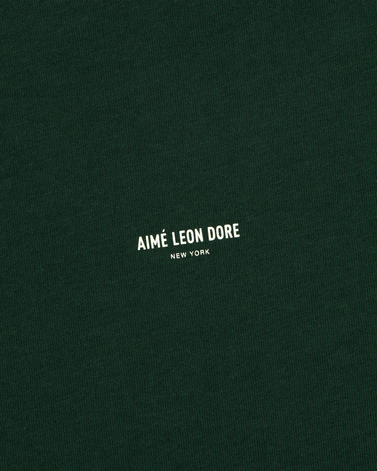 Dark green Micro Logo Tee with small white “Aimé Leon Dore New York” text in the center.