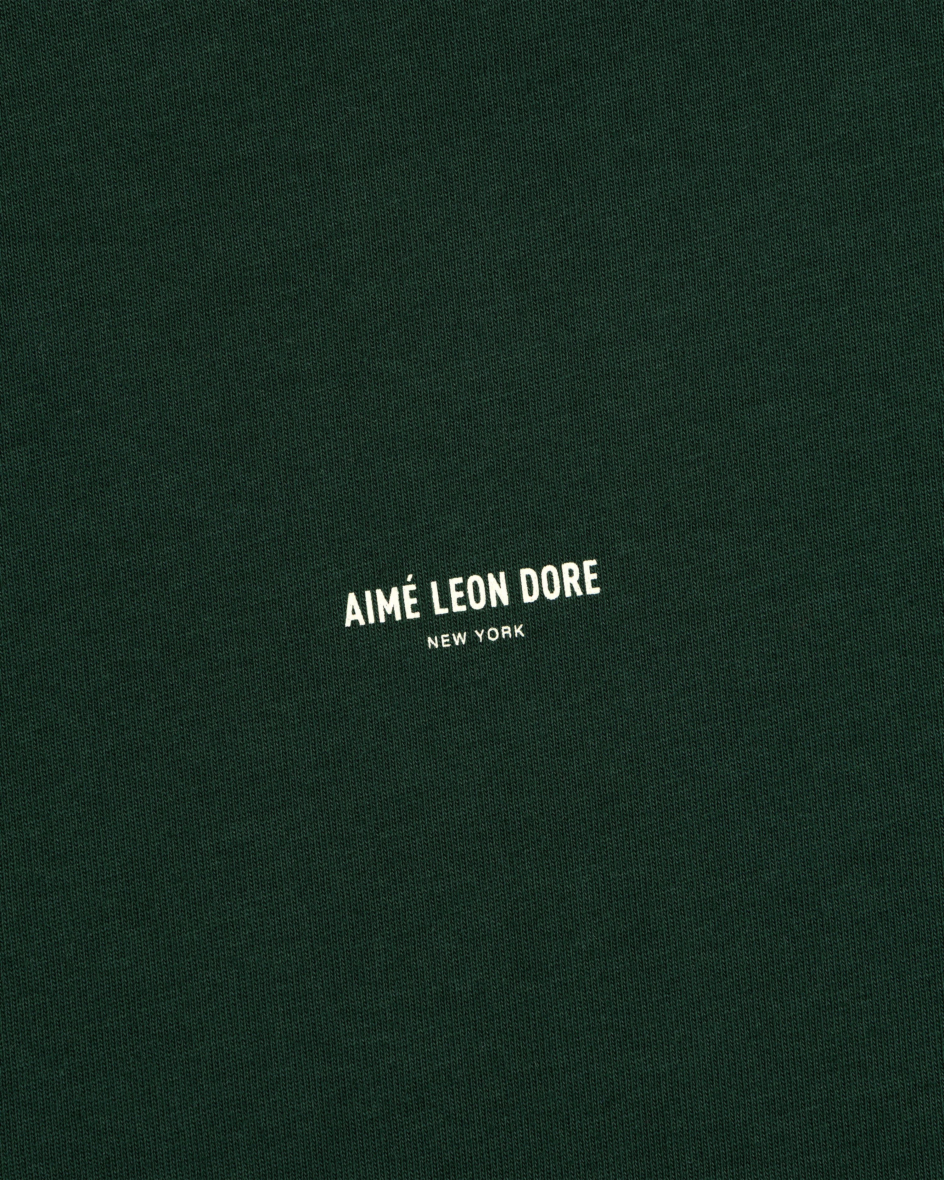Dark green Micro Logo Tee with small white “Aimé Leon Dore New York” text in the center.