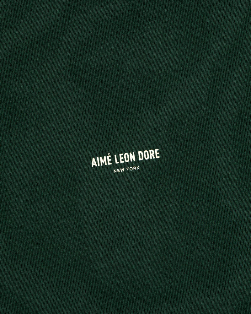 Dark green Micro Logo Tee with small white “Aimé Leon Dore New York” text in the center.