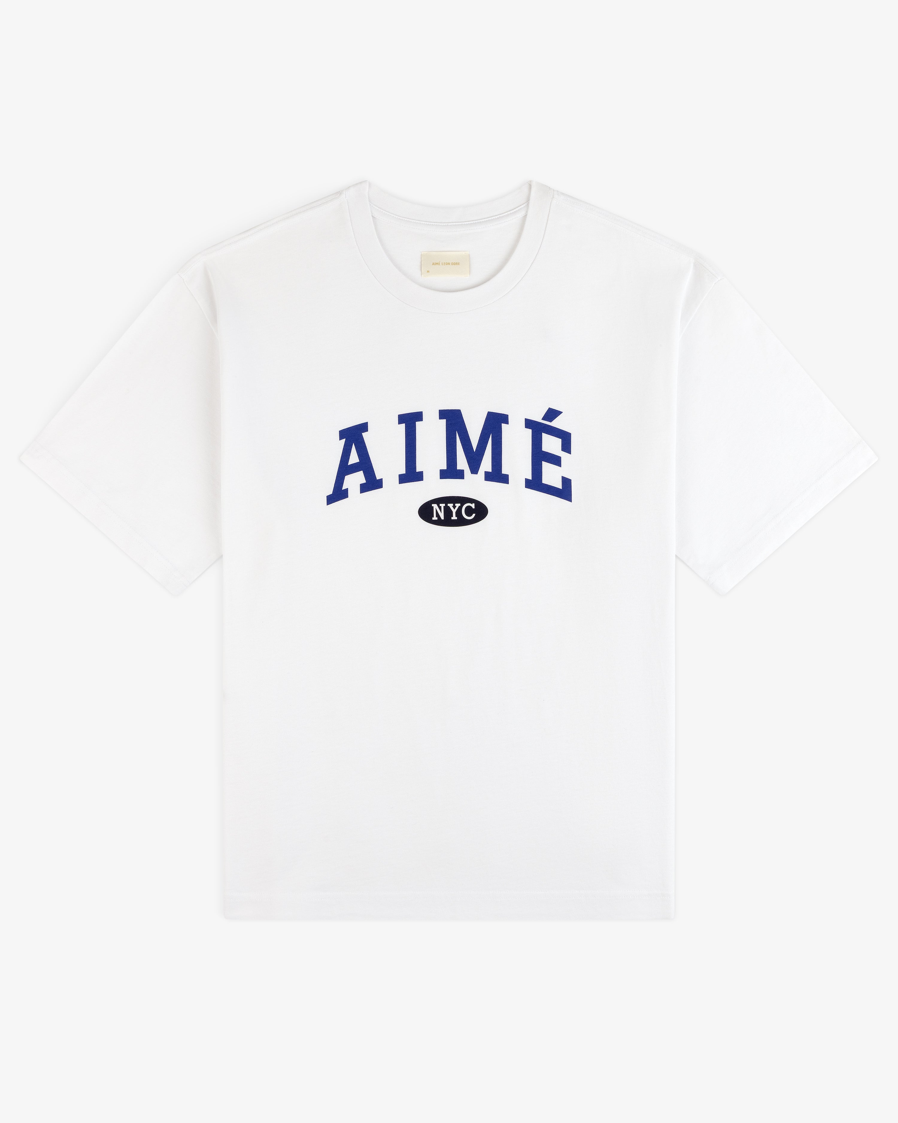 Aimé Souvenir Tee: White tee with blue AIMÉ lettering, black NYC oval below, centered on the chest.