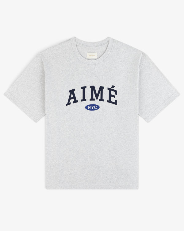 Aimé Souvenir Tee: Light gray tee with big navy AIMÉ text and a small blue NYC oval beneath.