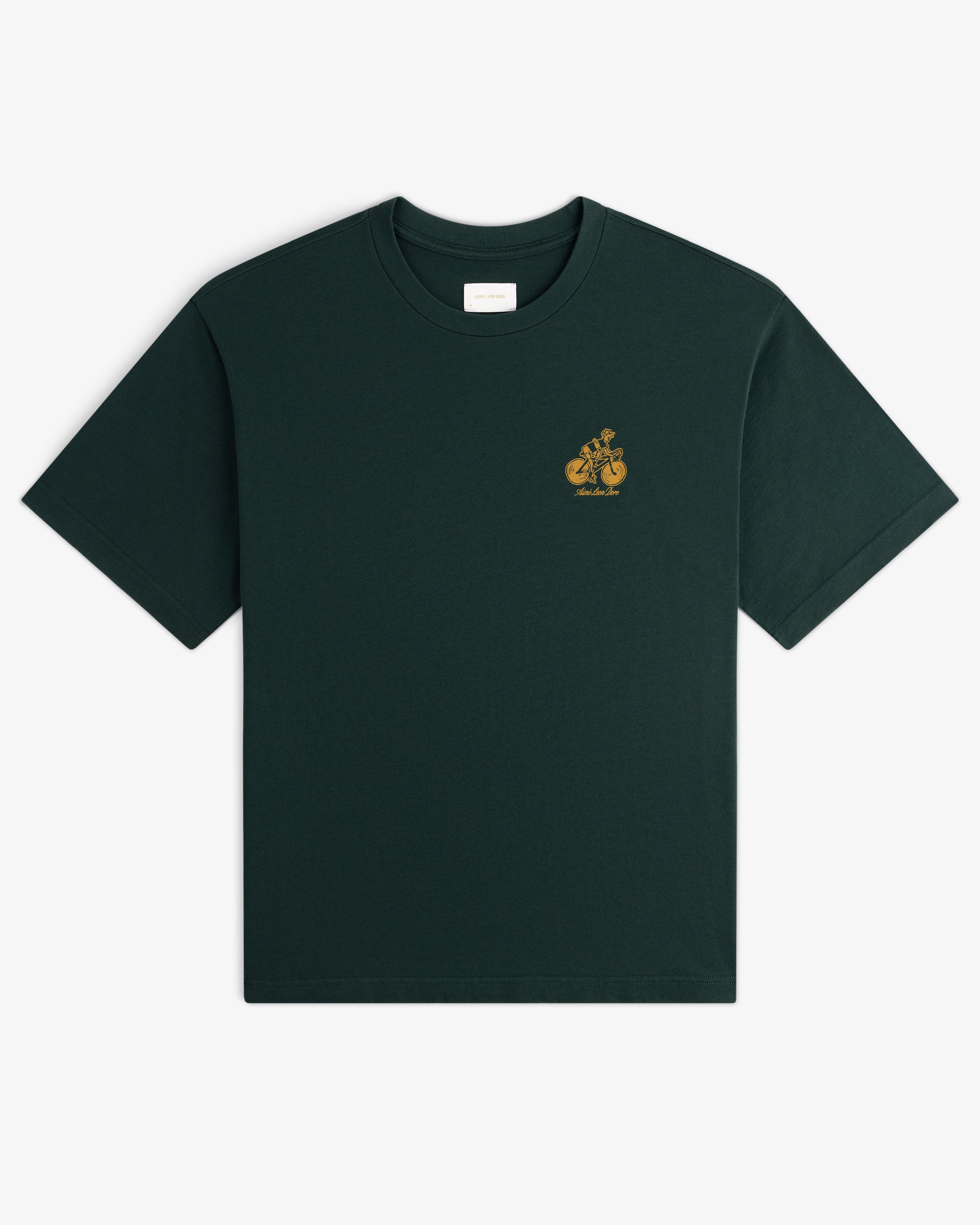 Aimé Tour Graphic Tee in dark green with a small yellow graphic and text on the left chest.