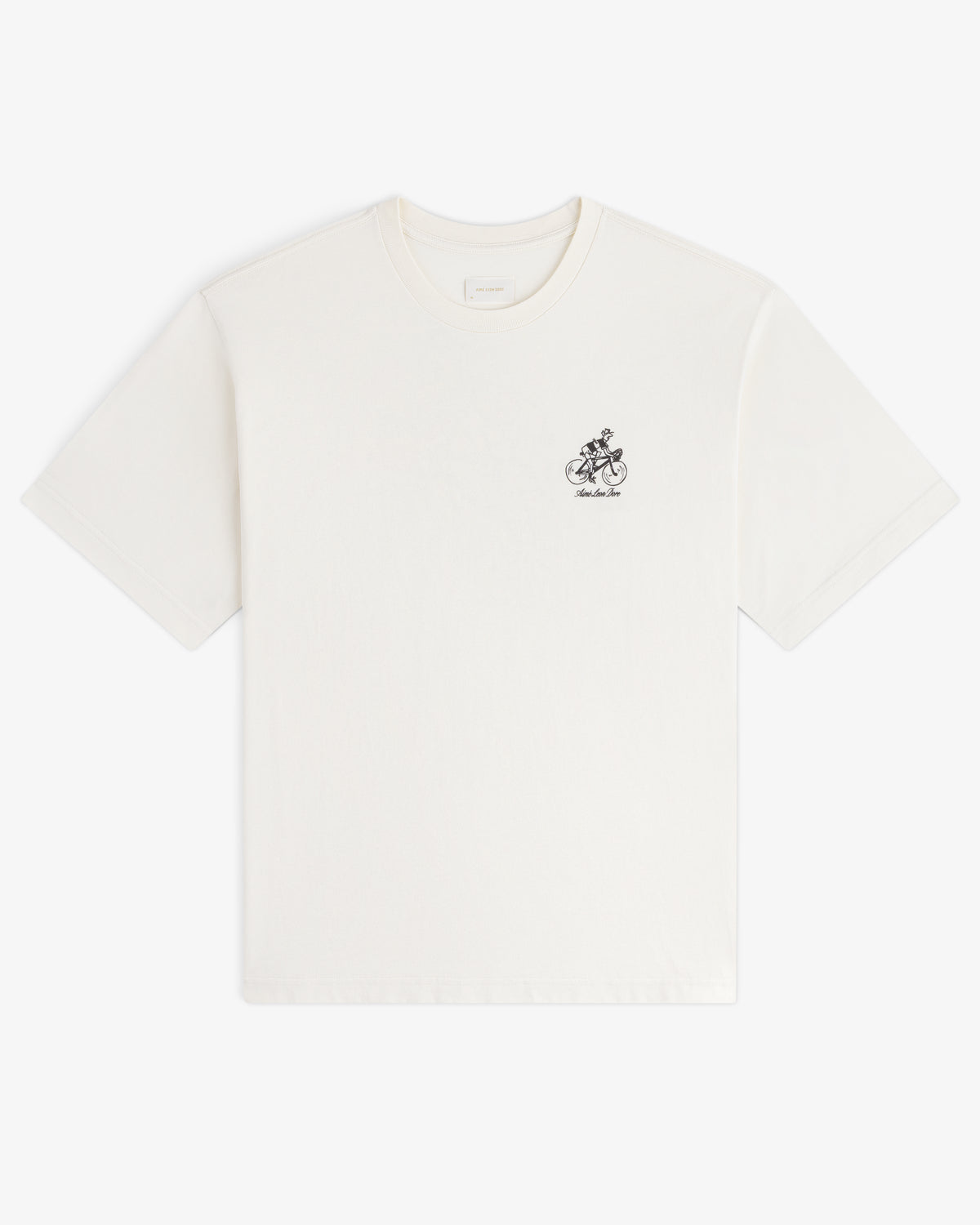 Aimé Tour Graphic Tee: white short-sleeve shirt with a small black graphic and text on the left chest.