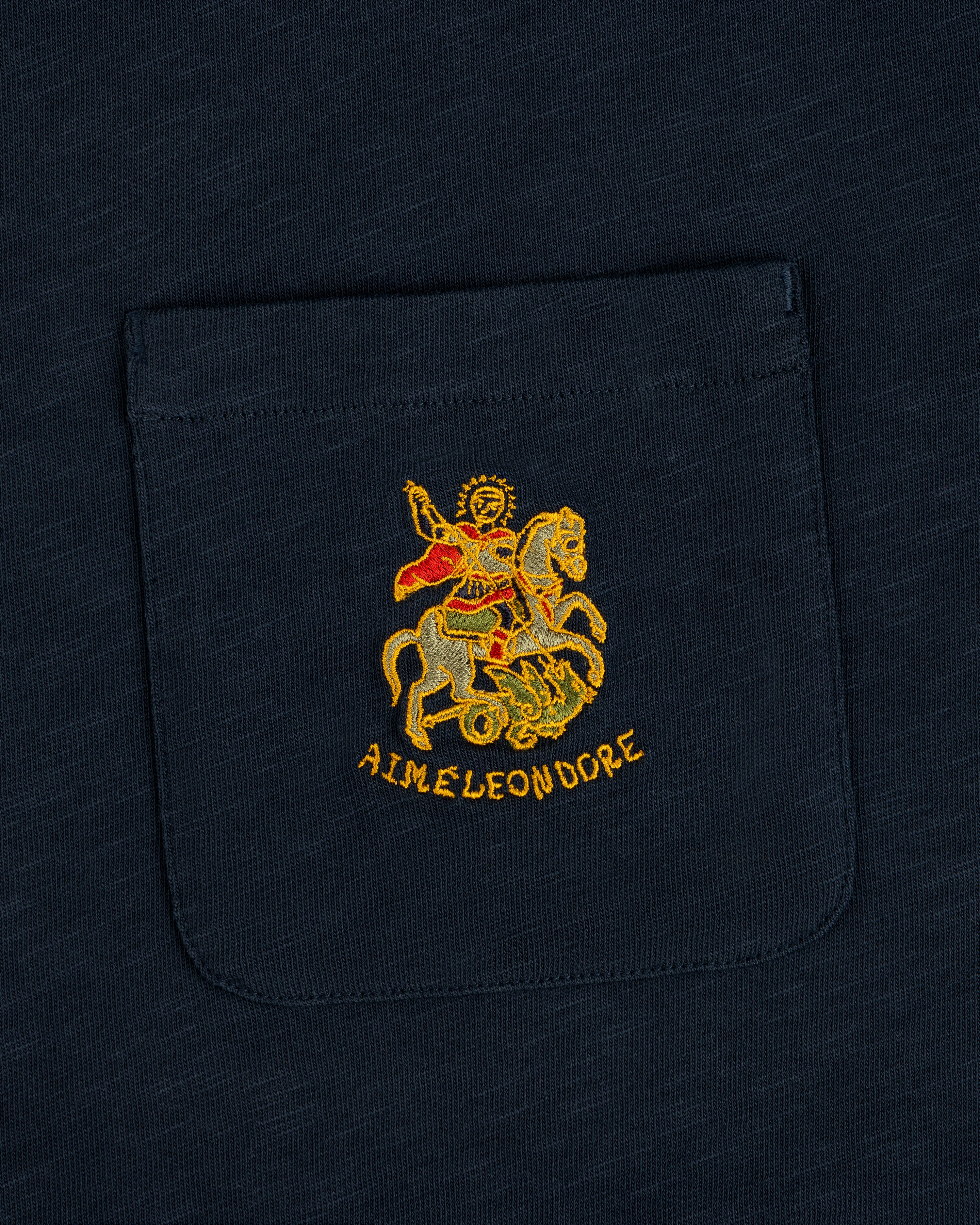 Saint George Slub Pocket Tee: Navy pocket tee with an embroidered knight slaying a dragon and AIME LEON DORE text.