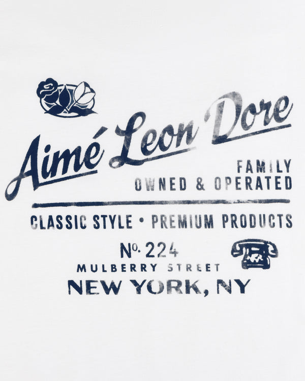 Neighborhood Tee featuring Aimé Leon Dore logo, roses, address, and vintage phone graphic in blue text.