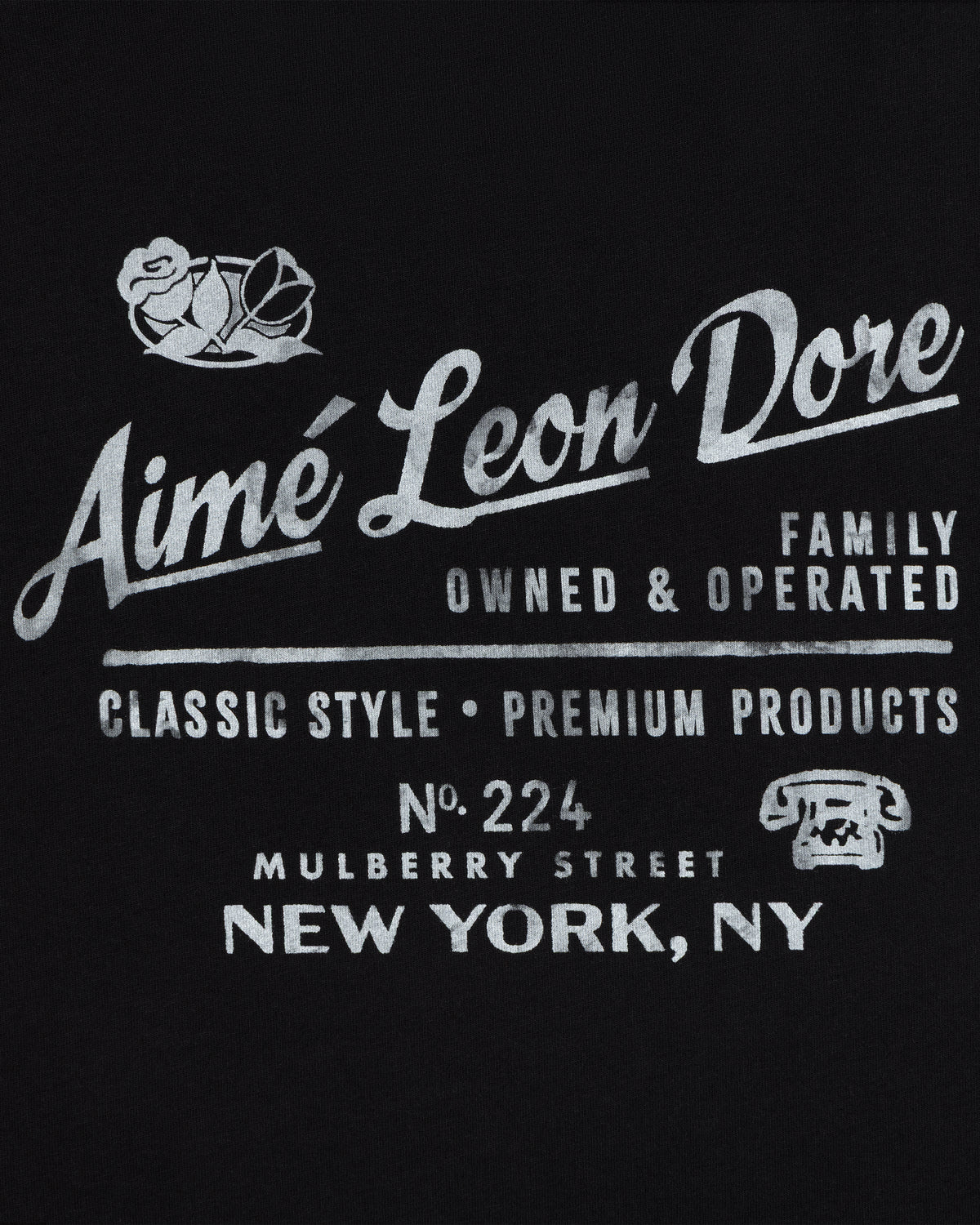 White text on black: Neighborhood Tee by Aimé Leon Dore, 224 Mulberry St, NY. Classic style. Rose & phone icon.