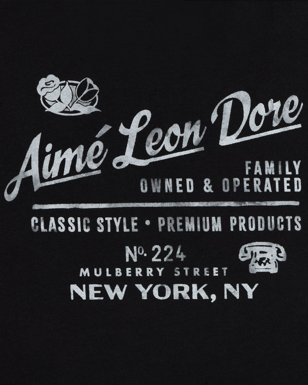 White text on black: Neighborhood Tee by Aimé Leon Dore, 224 Mulberry St, NY. Classic style. Rose & phone icon.