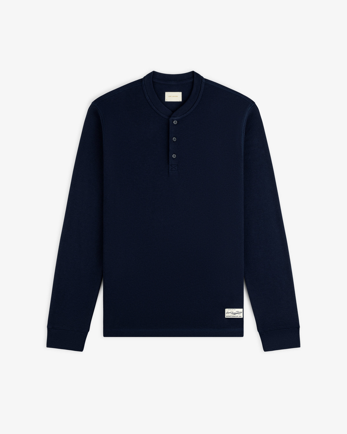 Navy blue Long-Sleeve Waffle Henley with a three-button placket and a small rectangular brand patch at the hem.