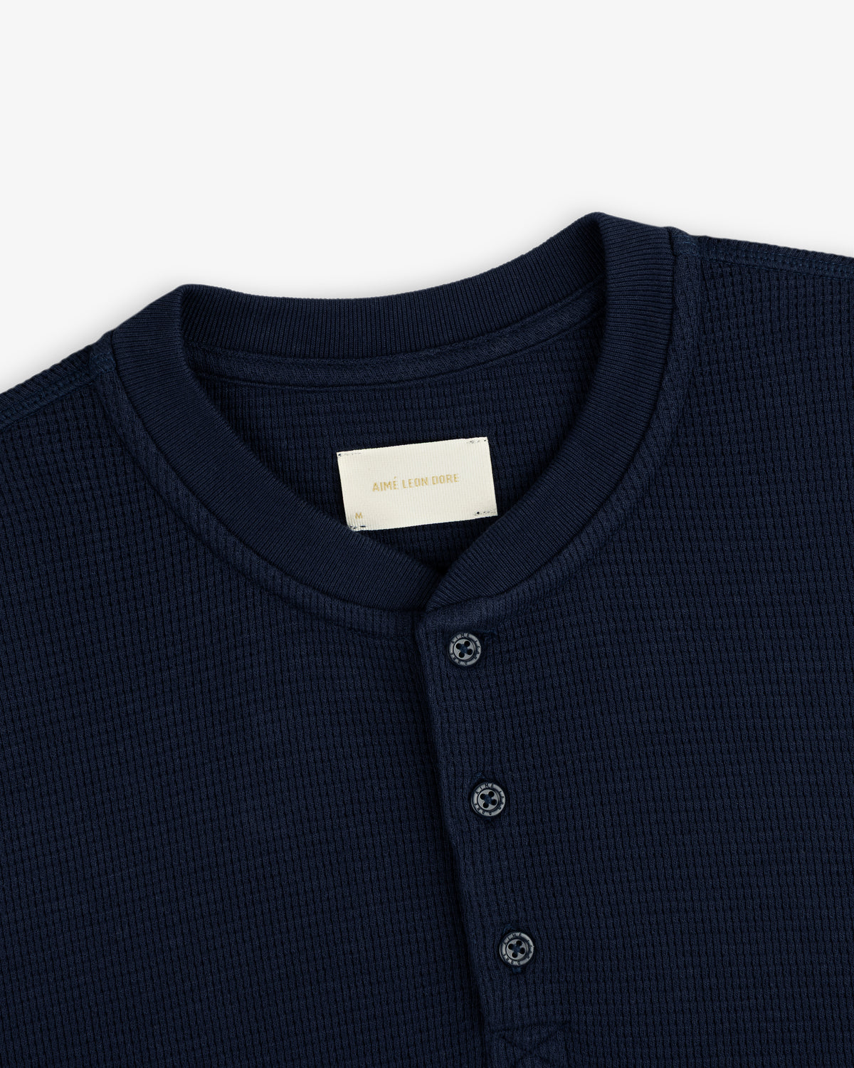 Navy blue Long-Sleeve Waffle Henley with a button placket and collar tag.