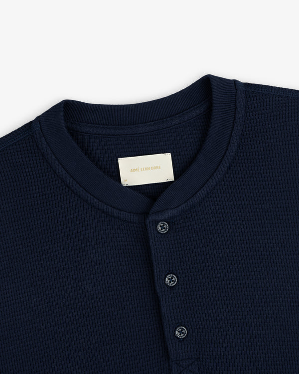 Navy blue Long-Sleeve Waffle Henley with a button placket and collar tag.