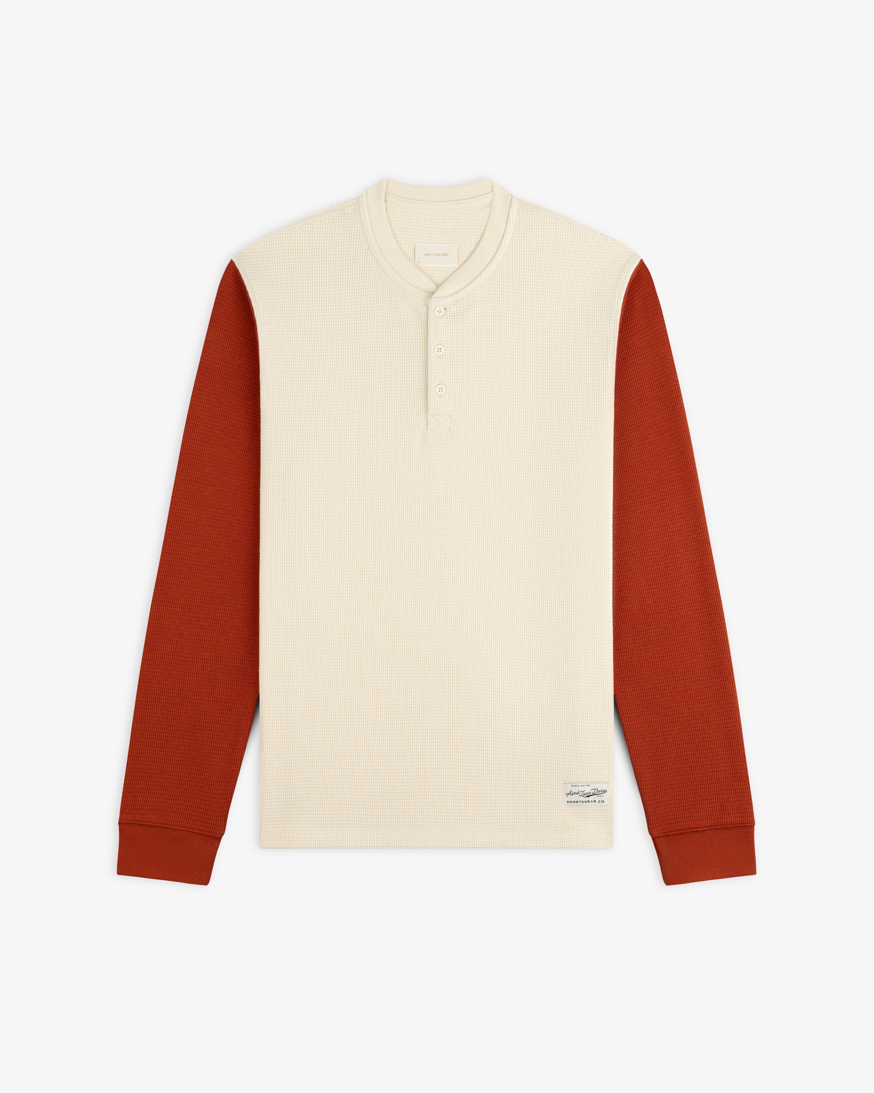 Long-Sleeve Waffle Henley with a cream-colored torso and rust-colored sleeves.