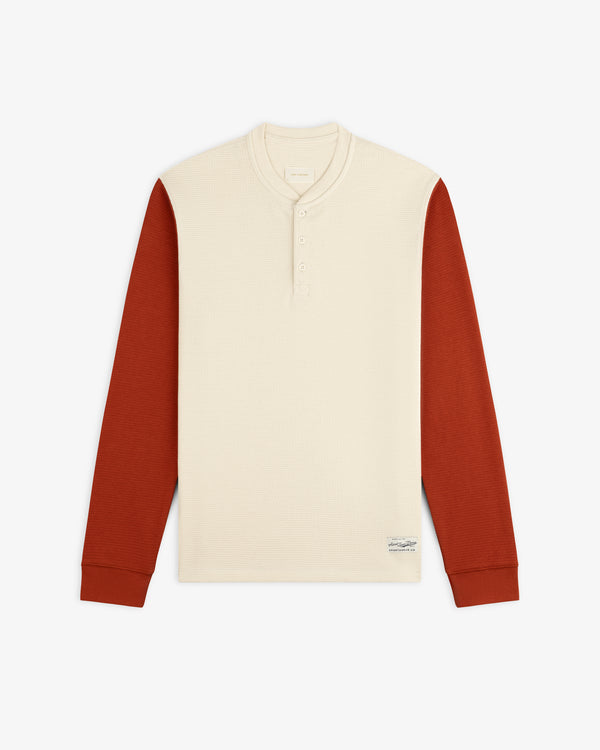 Long-Sleeve Waffle Henley with a cream-colored torso and rust-colored sleeves.