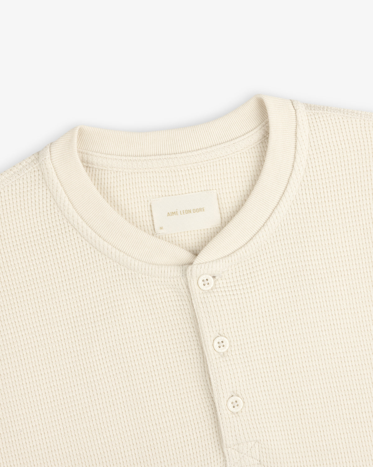 Off-white Long-Sleeve Waffle Henley with a four-button placket and crew neckline.