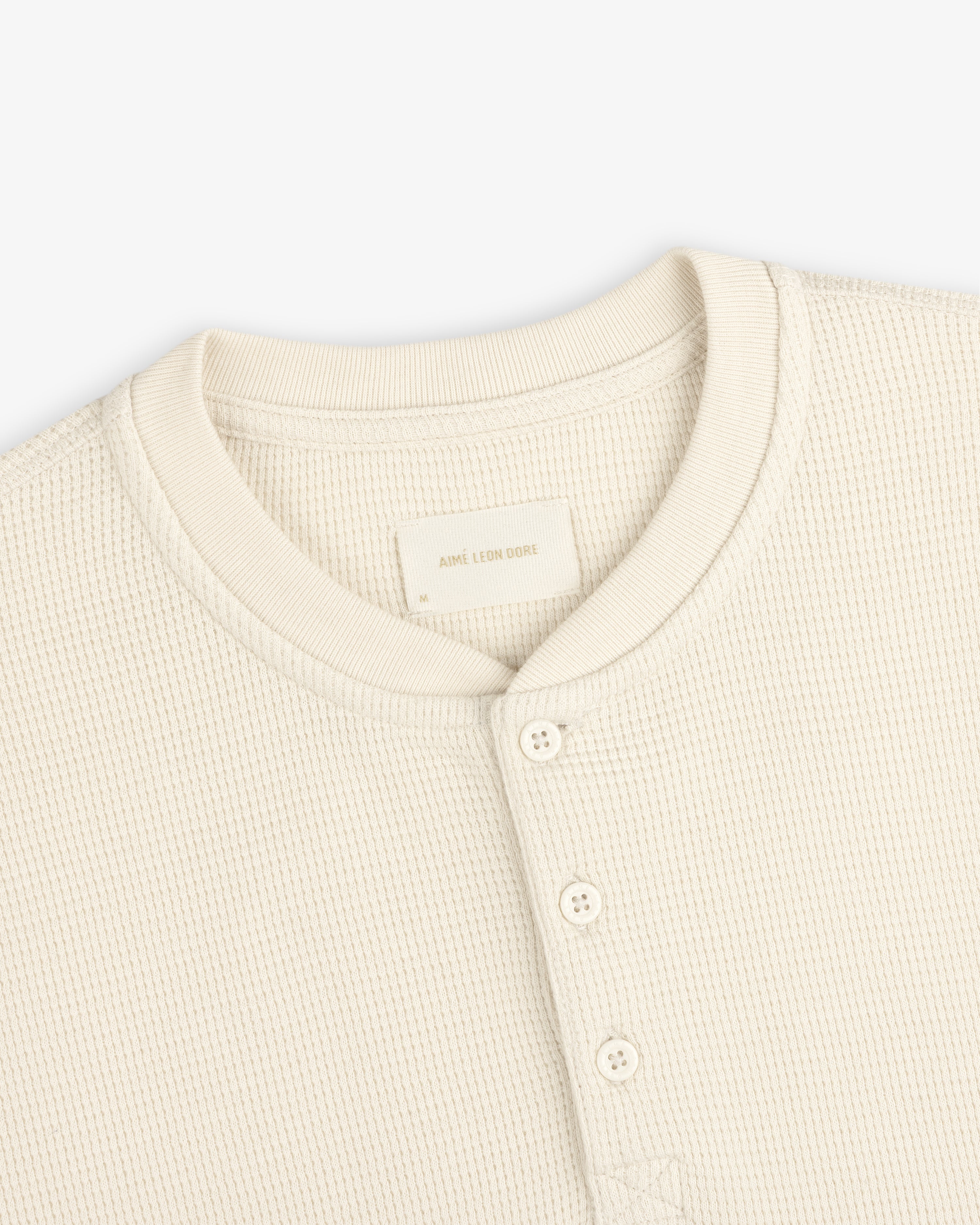 Off-white Long-Sleeve Waffle Henley with a four-button placket and crew neckline.