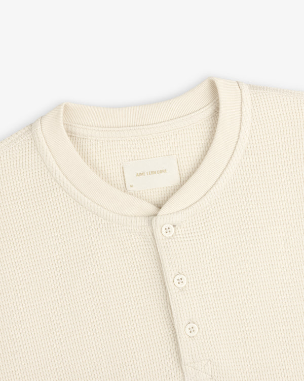 Off-white Long-Sleeve Waffle Henley with a four-button placket and crew neckline.