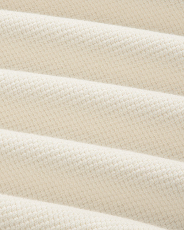 Close-up of the off-white Long-Sleeve Waffle Henley in a textured waffle-knit pattern.