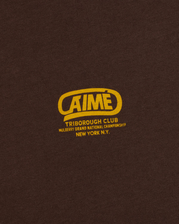 Dark brown Triborough Club Tee with a yellow logo reading Aimé, Triborough Club, and Mulberry Grand National Championship.