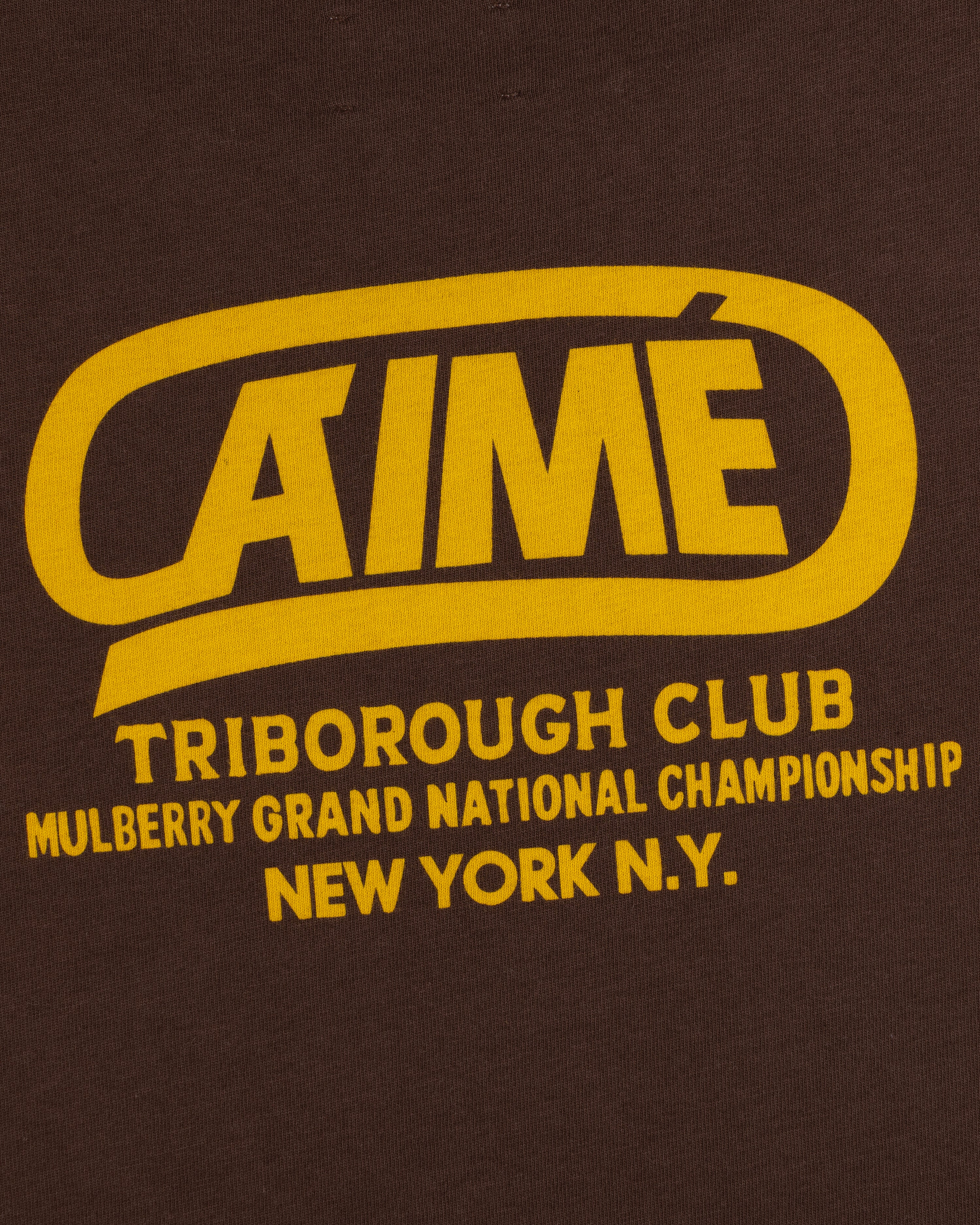 Dark brown Triborough Club Tee with yellow text reading Aimé Triborough Club Mulberry Grand National Championship New York.