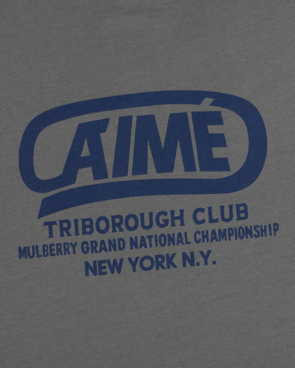 Grey Triborough Club Tee with a blue graphic reading AIMÉ TRIBOROUGH CLUB MULBERRY GRAND NATIONAL CHAMPIONSHIP NEW YORK N.Y.