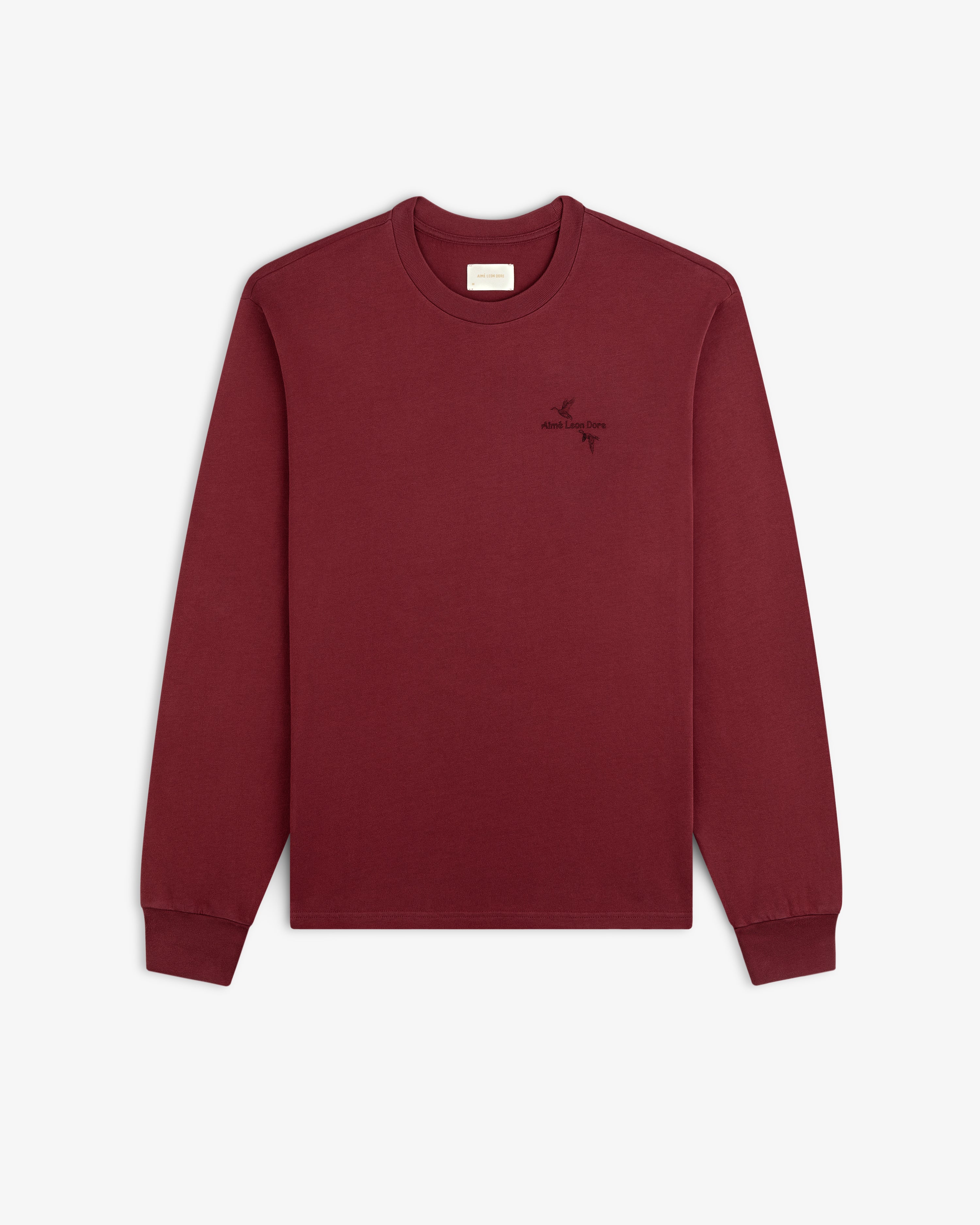 Maroon long-sleeve Long-Sleeve Retriever Tee with a small embroidered bird design and text on the chest.