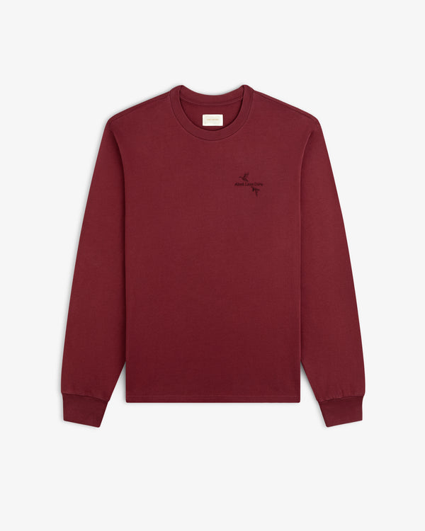 Maroon long-sleeve Long-Sleeve Retriever Tee with a small embroidered bird design and text on the chest.