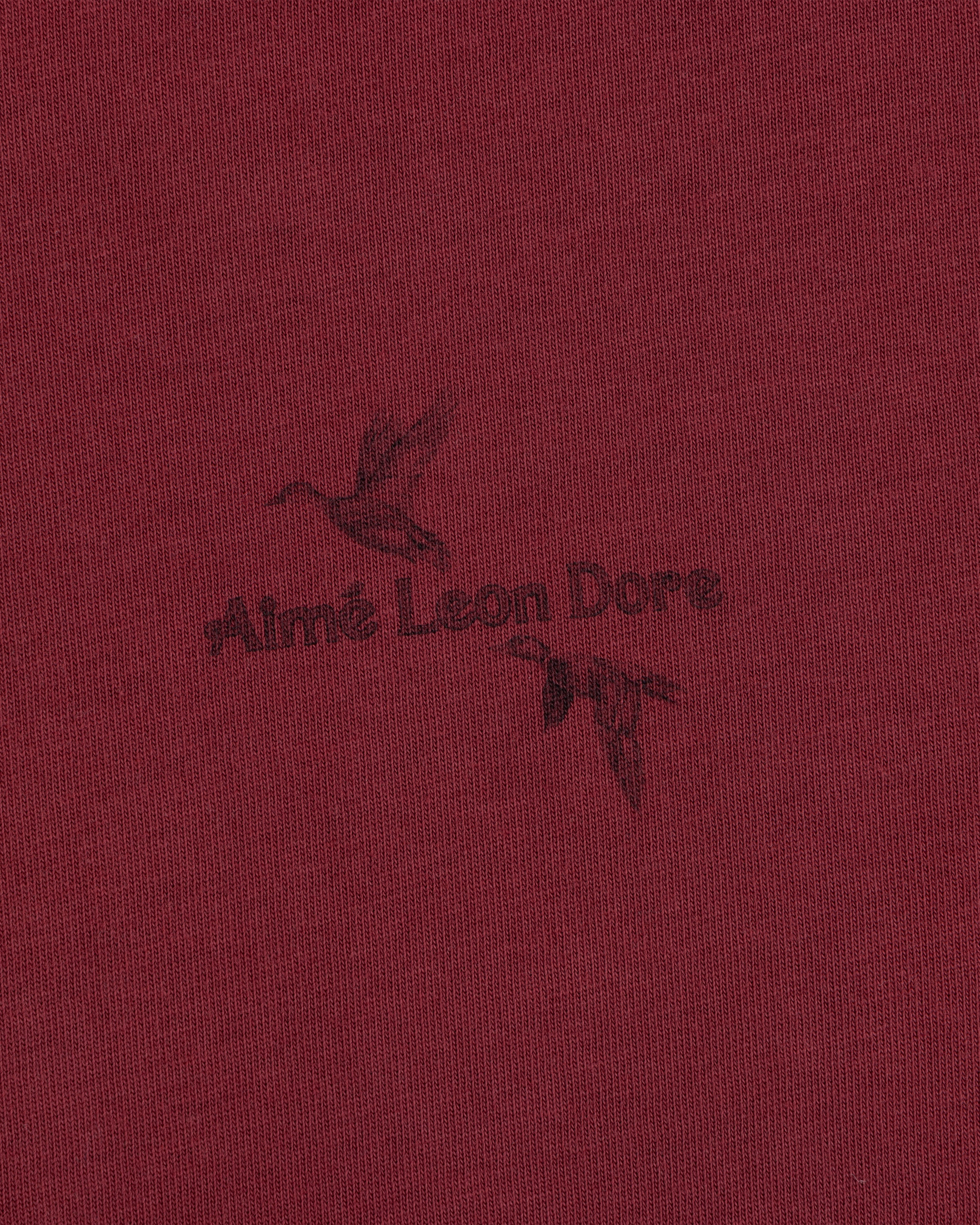 Maroon Long-Sleeve Retriever Tee featuring a black graphic of two flying ducks and the brand name in the center.
