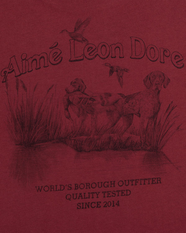 Dark red Long-Sleeve Retriever Tee featuring a graphic of two dogs in tall grass, flying ducks, and Aimé Leon Dore text.