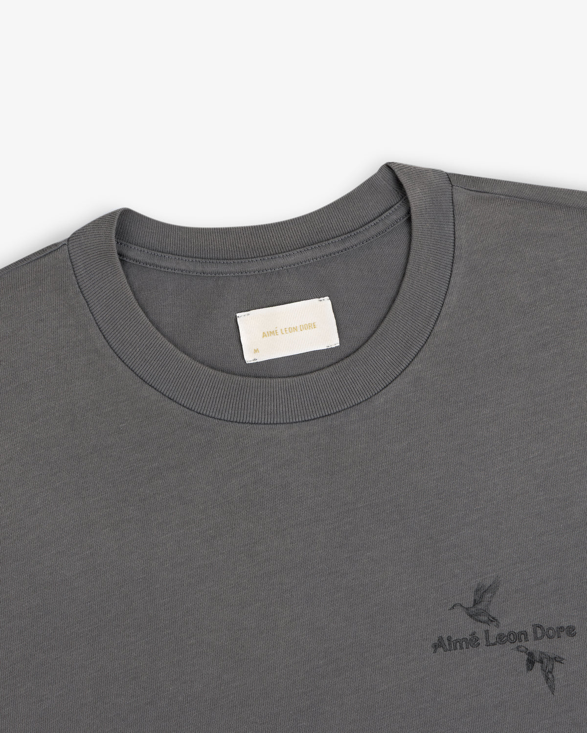 Grey Long-Sleeve Retriever Tee with a small bird graphic and brand logo on the chest.