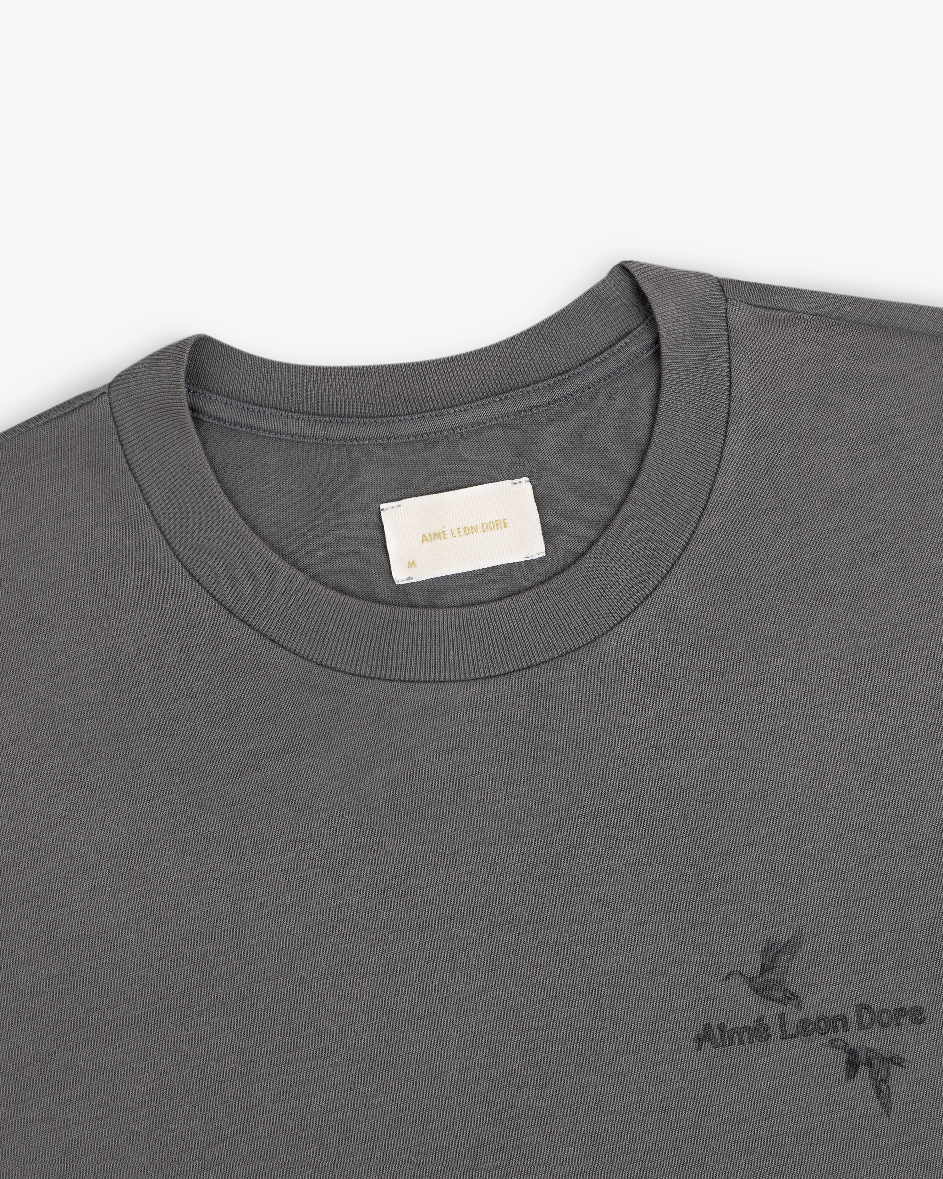 Grey Long-Sleeve Retriever Tee with a small bird graphic and brand logo on the chest.