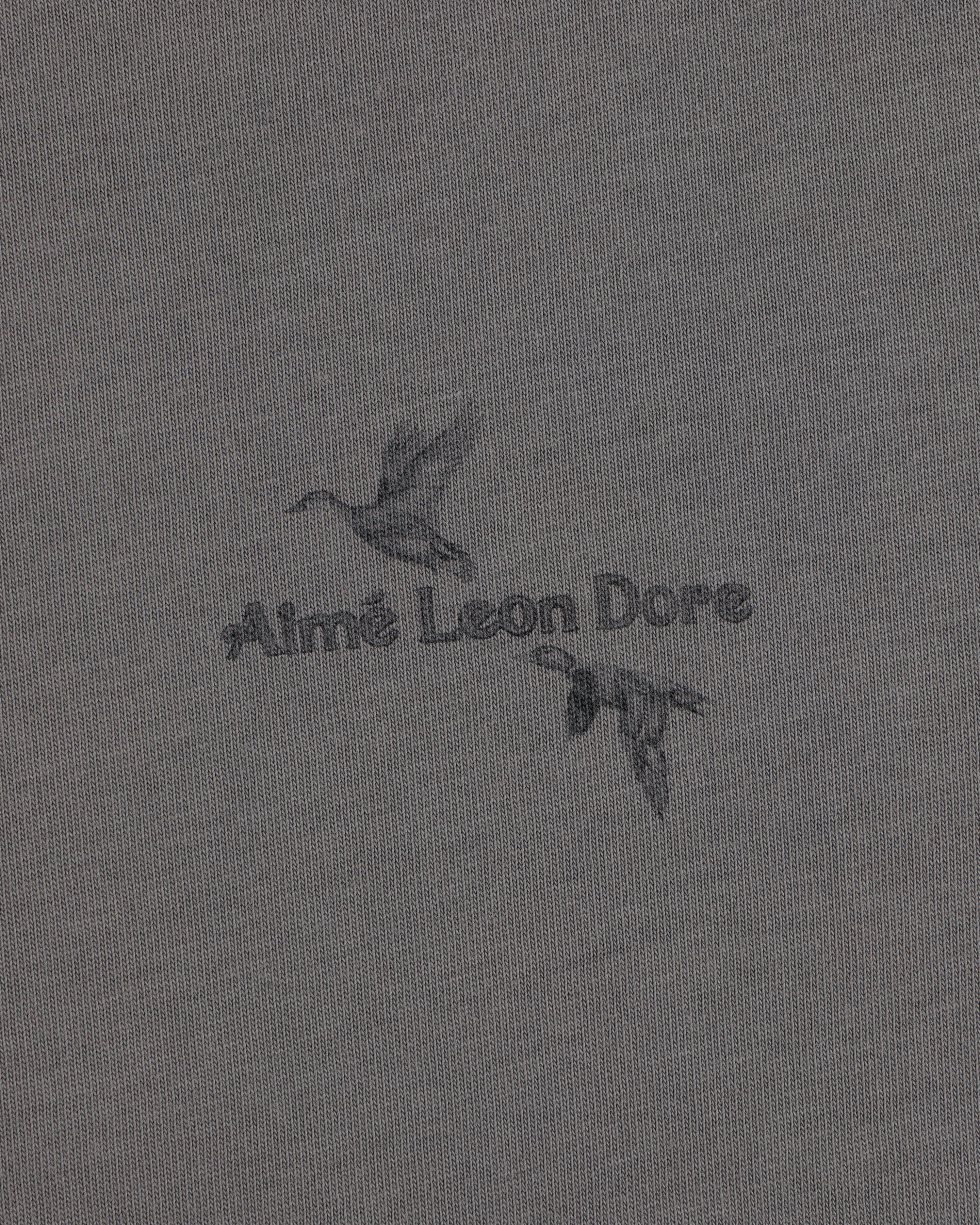 Long-Sleeve Retriever Tee featuring two ducks in flight with Aimé Leon Dore text on grey fabric.