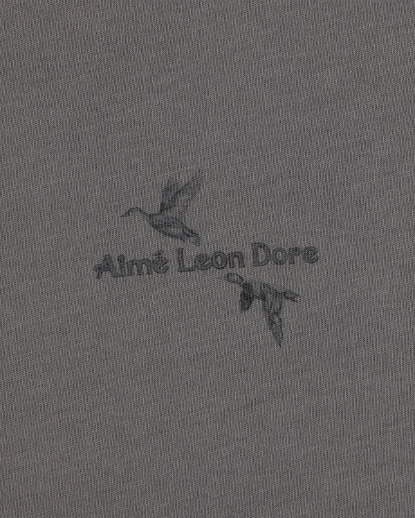 Long-Sleeve Retriever Tee featuring two ducks in flight with Aimé Leon Dore text on grey fabric.