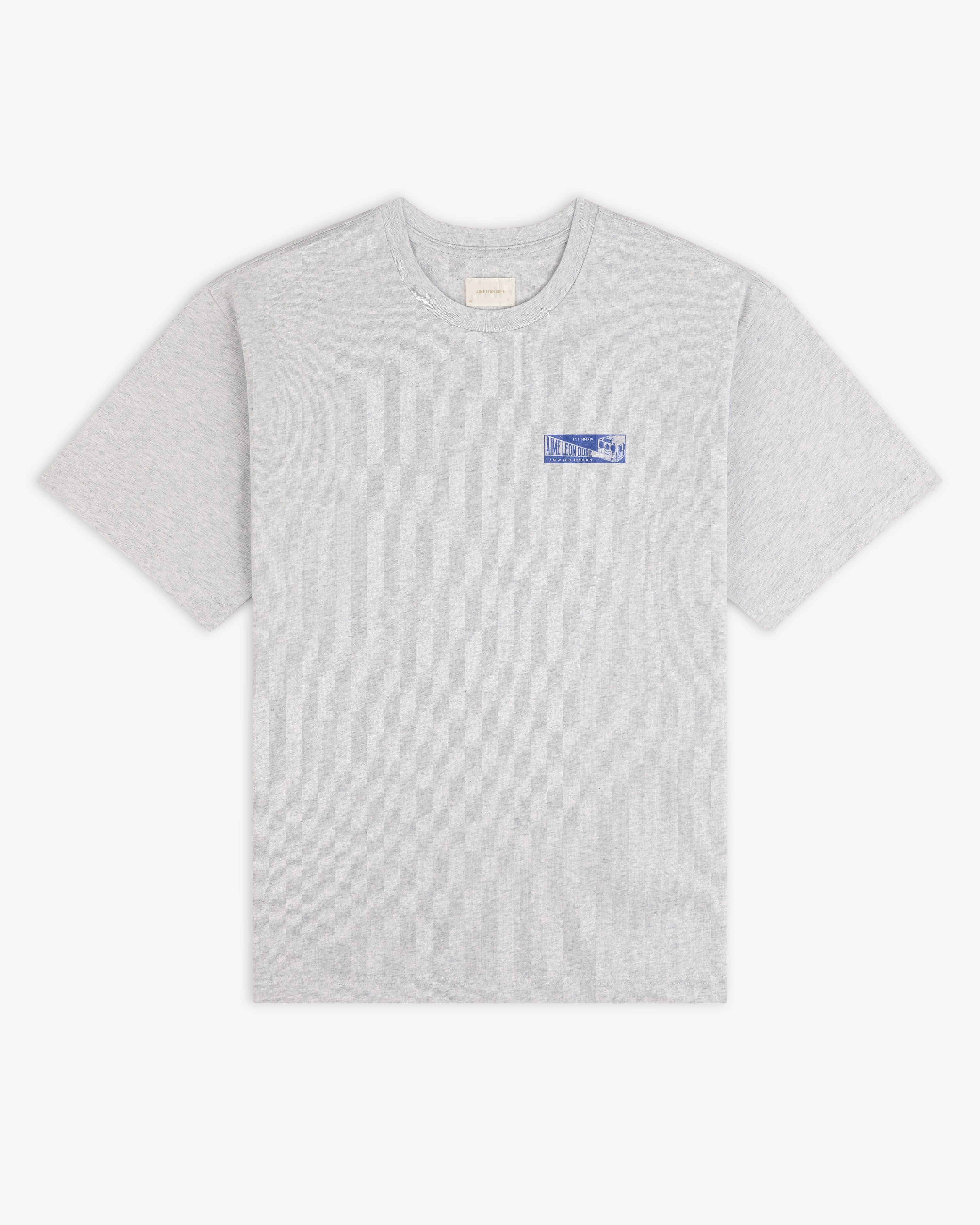 Aimé Transit Tee: grey crew neck t-shirt with a blue graphic logo on the left chest.
