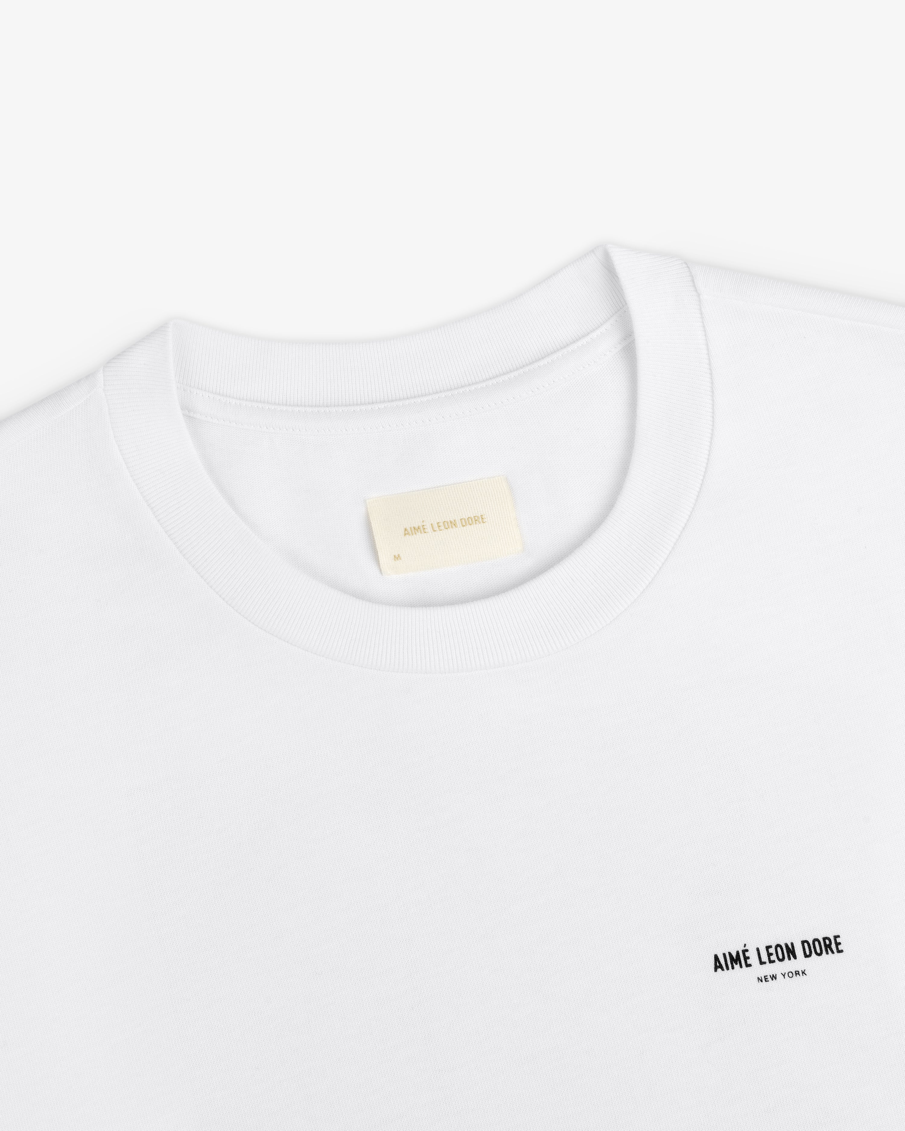 White Long-Sleeve Sailing Tee with a small logo on the chest and an inner neckline size label.