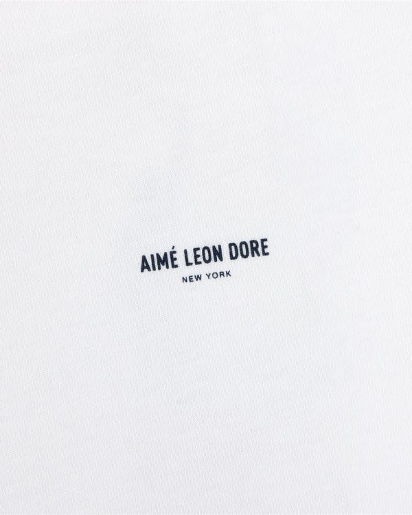 White Long-Sleeve Sailing Tee featuring the text Aimé Leon Dore New York printed in dark blue.