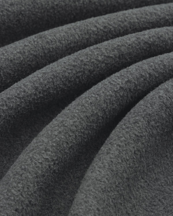 Close-up of soft Melange Fleece Shirt fabric in dark gray, highlighting its visible texture and gentle folds.